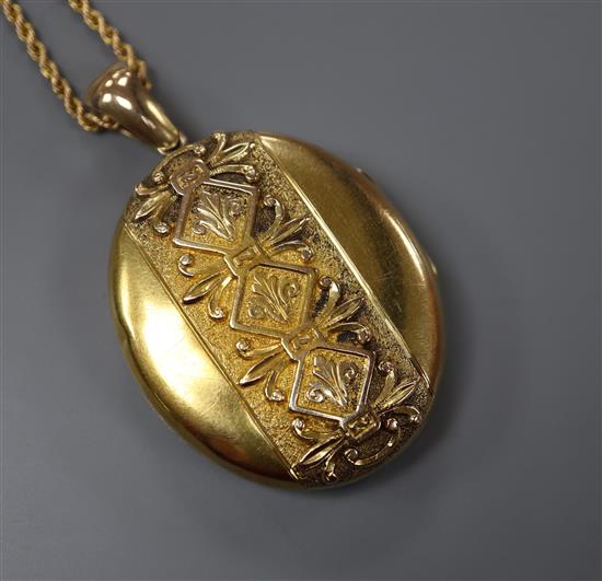 A Victorian yellow metal oval locket, on a yellow metal ropetwist chain, locket 40mm.